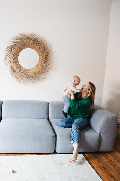 Alexa mit Baby auf blauem Sofa PYLLOW